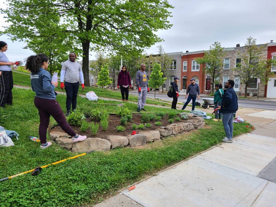 Volunteers planting and beautifying a landscaped park bed